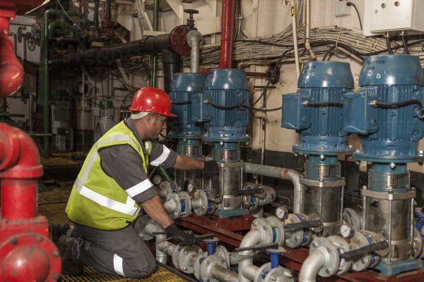 Mechanic working in engine room on a ship